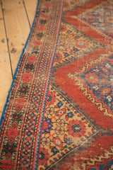 Antique Mahal runner: intricate geometric border, madder red field, blue edge, and pile wear.