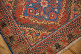 Antique Mahal runner corner with madder red field, blue serrated motifs, detailed border, and pile wear.