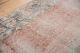 Blush and denim blue distressed Turkish Sparta rug with exposed foundation weave.