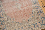 Distressed blush field, hard wear, and denim blue border on vintage Sparta rug runner.