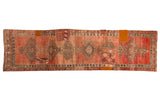 Vintage distressed patchwork Oushak runner, featuring geometric medallions and faded blush, rose tones.