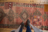 Distressed Oushak rug runner, showcasing a vibrant kilim patchwork and geometric medallion.