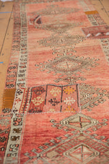 Hand-stitched kilim patchwork on a vintage Oushak runner, featuring varied blush, faded red, and gold patterns.