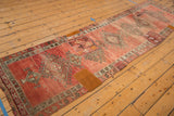 Tan reinforcement patch with white stitching on the distressed Oushak runner.