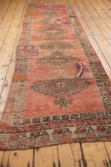 Distressed geometric medallion with fragmented kilim patchwork and wear to knot heads.