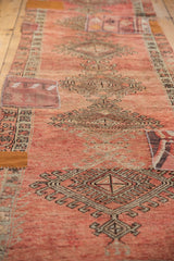 Faded blush Oushak runner with geometric medallions and intricate kilim patchwork.