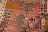 Detail of hand-stitched colorful kilim and ochre fabric patches on a blush Oushak runner.