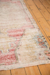 Faded cherry red and saffron yellow arabesque floral motifs on the distressed Oushak pile.
