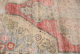 Distressed Oushak rug: arabesque floral pattern in cherry red, saffron, oxidized silver, and foundation wear.
