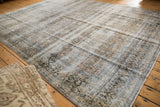 Distressed vintage Kashan corner, faded floral design in ivory, dusty teal, and gold.