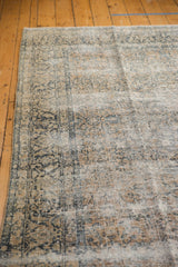 Distressed pile texture of vintage Kashan rug, showing ivory, sand, and teal floral vinery.