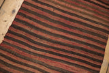 Hand woven Turkish Kilim rug with varying brick red, brown, and charcoal striped pattern.