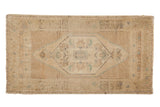 Vintage Distressed Oushak rug, ivory and beige field, pale blue-green elongated medallion.