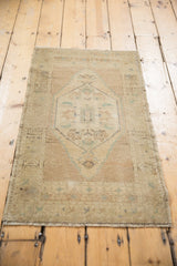 Even wear and distressed texture on the vintage Oushak rug's side.