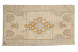 Distressed hand-knotted Oushak rug, stepped medallion in beige, pale bronze, silver mauve, ocean green.