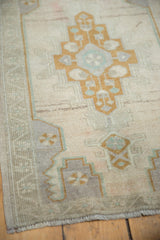 Distressed Oushak rug with geometric pattern in pale bronze, silver mauve, ocean green.