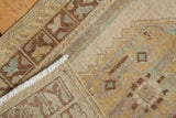 Edge of the vintage distressed Oushak rug reveals worn pile and hand-knotted foundation.