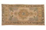 Distressed vintage Oushak rug runner, hand-knotted, ivory and silver floral medallion. 1'9