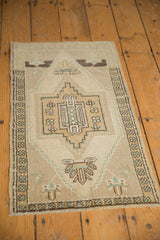 Vintage Oushak rug's geometric side border and distressed low pile.