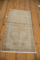 Distressed Oushak rug: scrolling vinery, tree-of-life medallions, meandering border in pale tones.
