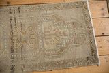 Distressed vintage Oushak runner texture, muted geometric pattern, and intact side selvage.