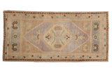 Distressed vintage Oushak runner: mauve serrated medallion, antique ivory, pale turquoise accents.
