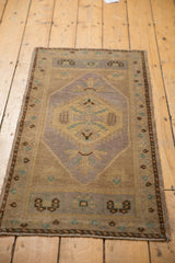 Distressed Oushak runner corner, showing mauve, gold, turquoise, and original selvage.