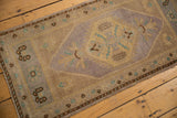 Soft mauve, gold, and ivory distressed Oushak runner with hexagonal medallion pattern.