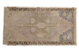 Distressed vintage Oushak runner with muted mauve and beige central medallion. 1'9