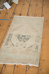 Fringed end of the distressed vintage Oushak rug, showing abrash and worn pile.