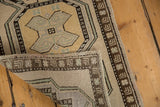 Vintage distressed Oushak rug corner, showing its hand-knotted foundation and original selvages.