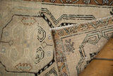 Hand-knotted back and side selvage of distressed vintage Oushak rug in ivory, green, and bronze.