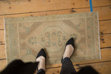 Distressed vintage Turkish Oushak rug mat, hexagonal medallion in sea foam green and ivory.