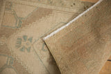 Distressed ivory beige Oushak rug pile revealing its tightly hand-knotted foundation and selvage.