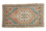 Distressed vintage Oushak rug mat with hexagonal floral medallion, apricot, ocean blue, and bronze, 1'8