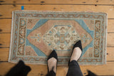 Distressed Oushak rug mat showcasing its worn texture, hexagonal medallion, and soft pastel colors.