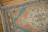 Hexagonal floral medallion and reciprocating spandrels in distressed Oushak rug texture.