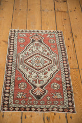 Textured hexagonal medallion and floral field with rust, ivory, and charcoal on this vintage Oushak rug.