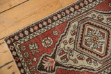 Distressed Oushak rug mat displaying hexagonal medallion, rust field, and worn floral motifs.