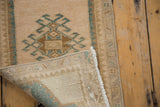 Hand-knotted foundation, fringe, and distressed pile of vintage Oushak rug.
