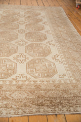 Vintage distressed Ersari carpet, close-up of tone-on-tone ivory and beige geometric border.