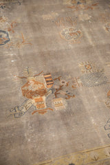 Distressed Art Deco Indo carpet with faded mauve grey field, bronze planter motifs, visible wear.