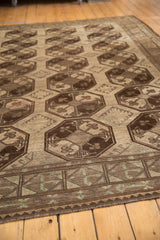 Distressed Ersari rug showing geometric border in chocolate brown and oxidized green.