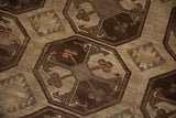 Geometric repeating guls in chocolate brown, ivory, with tangerine accents on distressed Ersari.