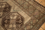 Distressed vintage Ersari carpet's geometric guls and borders in chocolate brown, ivory, and copper green.