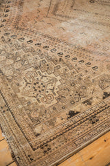 Distressed vintage Shiraz carpet corner, showing secured sides and faded geometric patterns.