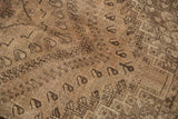 Distressed texture and muted tones of a vintage Shiraz carpet with subtle boteh motifs.