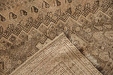 Corner view of the distressed vintage Shiraz rug, showing worn pile, woven foundation, and fringes.