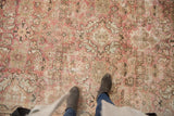 Visible wear on a distressed Mahal rug, with allover floral motifs in dusty raspberry and ivory.