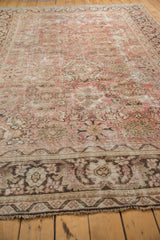Distressed Mahal carpet end, blush and charcoal floral border, with frayed fringe.
